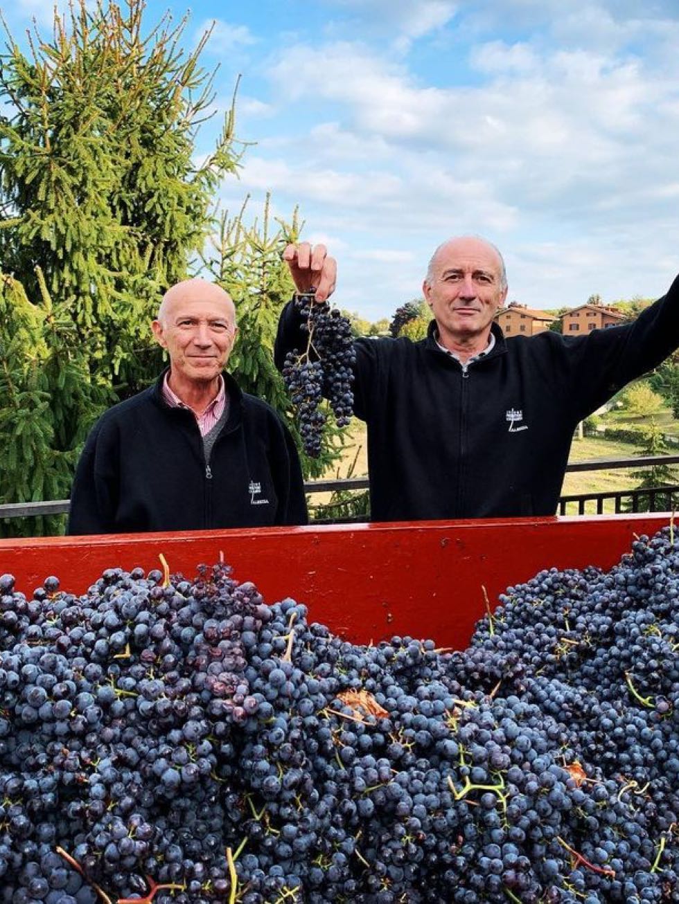 Valter and Paolo with grapes
